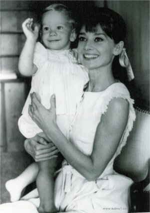 Audrey Hepburn holding child - white dress.jpg